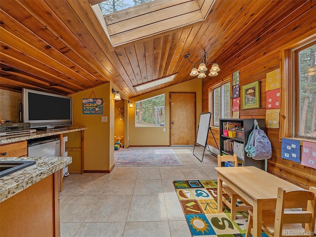 7585 Native Dancer Trl, Evergreen, CO 80439 - playroom with a skylight, plenty of natural light, lofted ceiling, a chandelier, and light tile patterned flooring