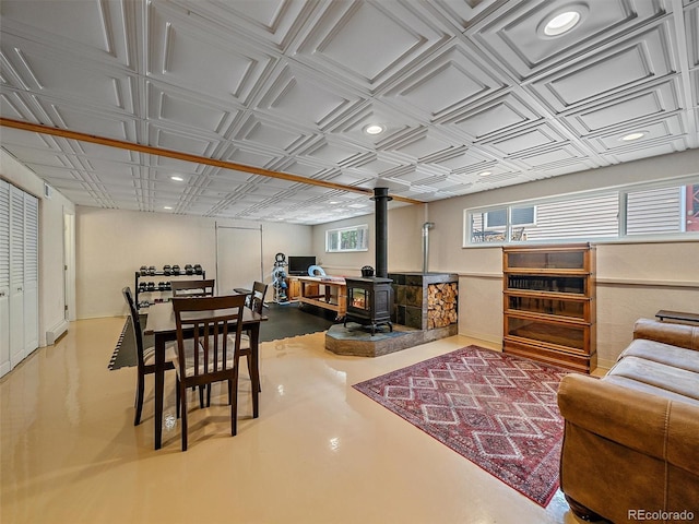 7585 Native Dancer Trl, Evergreen, CO 80439 - dining room with a wood stove, recessed lighting, an ornate ceiling, and finished concrete flooring