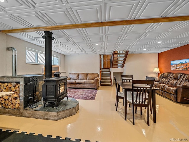 7585 Native Dancer Trl, Evergreen, CO 80439 - living area with a wood stove, an ornate ceiling, recessed lighting, and stairs