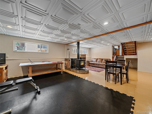 7585 Native Dancer Trl, Evergreen, CO 80439 - playroom featuring a wood stove, healthy amount of natural light, recessed lighting, an ornate ceiling, and baseboards