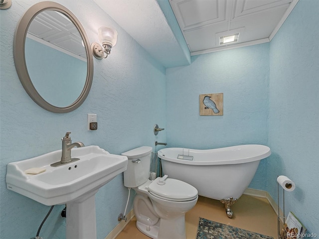 7585 Native Dancer Trl, Evergreen, CO 80439 - bathroom with a freestanding tub, toilet, baseboards, and a textured wall