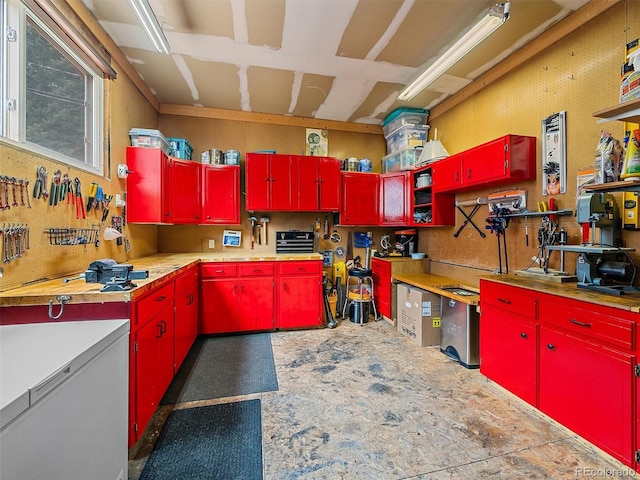 7585 Native Dancer Trl, Evergreen, CO 80439 - kitchen featuring red cabinetry, refrigerator, and light countertops