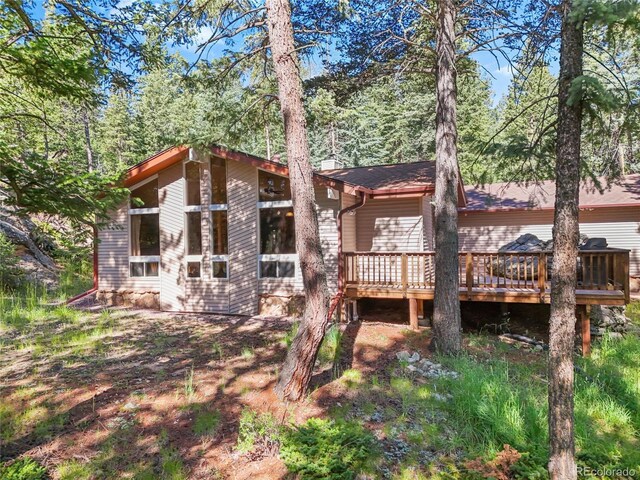 7585 Native Dancer Trl, Evergreen, CO 80439 - rear view of property with a wooden deck and a chimney