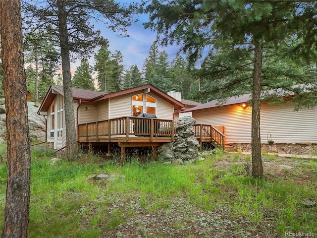 7585 Native Dancer Trl, Evergreen, CO 80439 - back of house with a wooden deck and a chimney