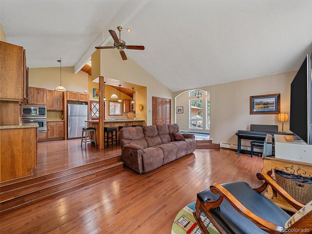7585 Native Dancer Trl, Evergreen, CO 80439 - living area with beam ceiling, wood-type flooring, ceiling fan, and high vaulted ceiling