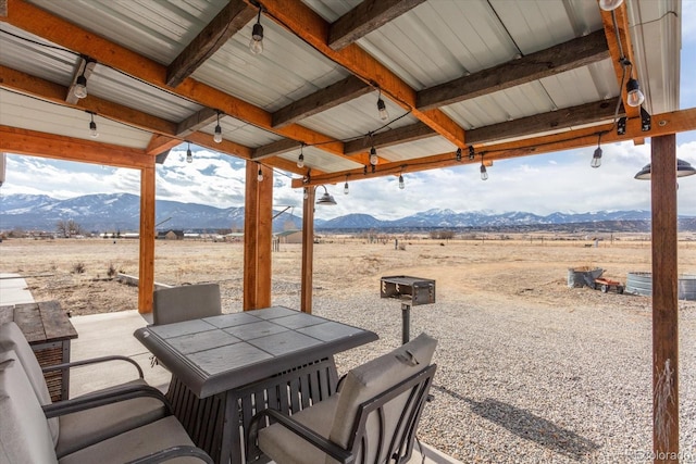 view of patio / terrace with a mountain view and a rural view