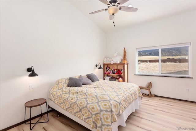 bedroom featuring vaulted ceiling and light hardwood / wood-style flooring