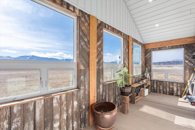 sunroom with a mountain view and lofted ceiling