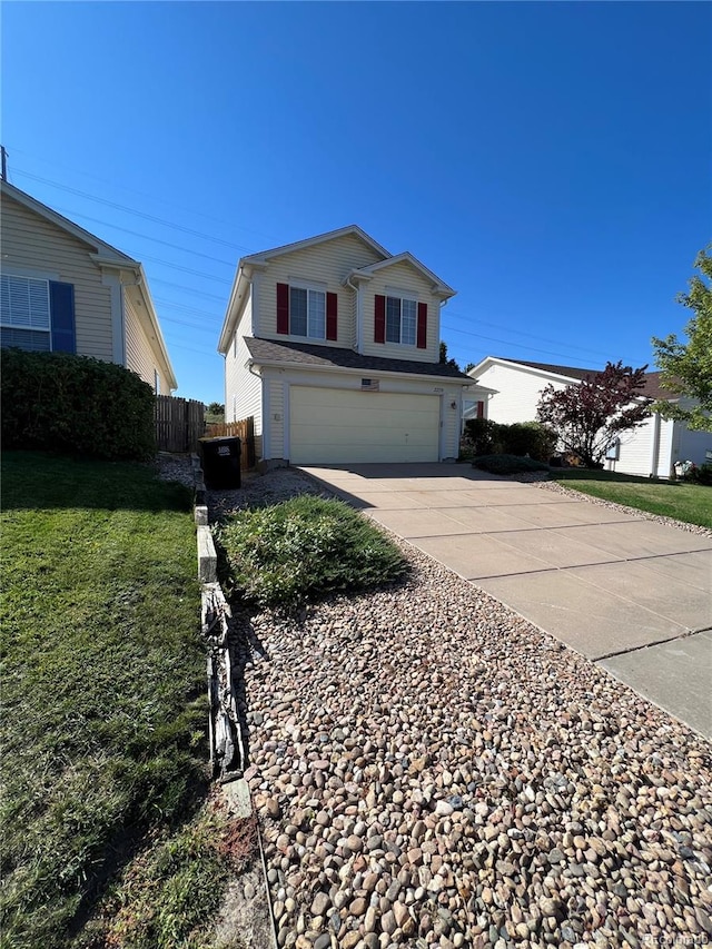 front facade featuring a front yard and a garage