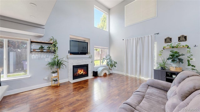 21570 E 40th Pl, Denver, CO 80249 - living room with wood finished floors, a towering ceiling, and a stone fireplace