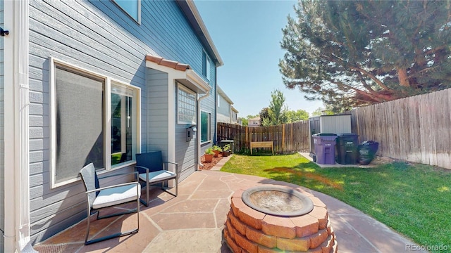 21570 E 40th Pl, Denver, CO 80249 - fenced backyard with a patio and an outdoor fire pit