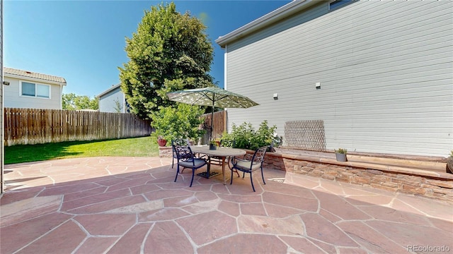 21570 E 40th Pl, Denver, CO 80249 - fenced backyard with a patio area and outdoor dining area