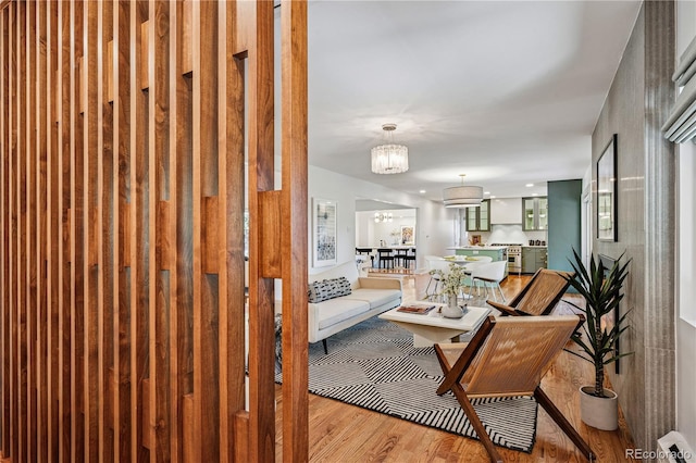 living room with wood finished floors and a chandelier