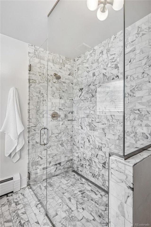 bathroom featuring baseboard heating and a stall shower