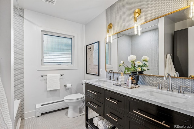 full bathroom featuring baseboard heating, toilet, double vanity, a shower, and baseboards