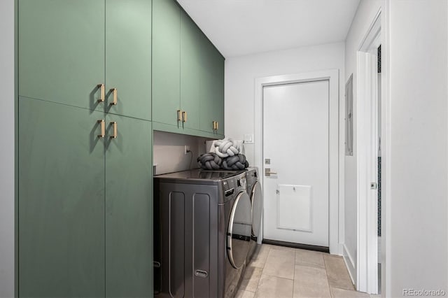 clothes washing area featuring cabinet space, washer and clothes dryer, electric panel, and light tile patterned flooring