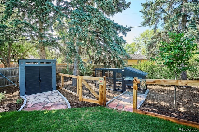 fenced backyard featuring a shed and an outbuilding