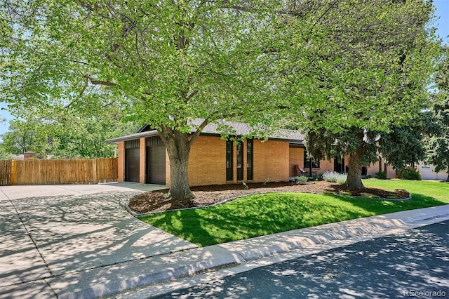 view of front of house with driveway, a garage, and brick siding