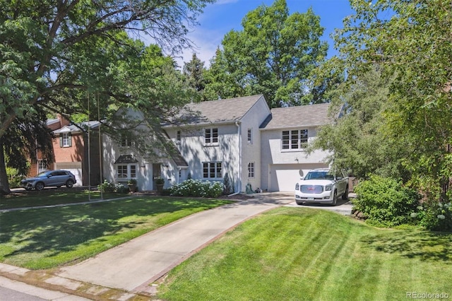 435 Ivanhoe St, Denver, CO 80220 - view of front facade with stucco siding, concrete driveway, a front lawn, and an attached garage