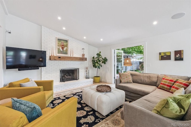 435 Ivanhoe St, Denver, CO 80220 - living area featuring lofted ceiling, a brick fireplace, and recessed lighting