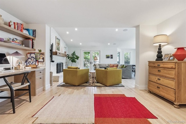 435 Ivanhoe St, Denver, CO 80220 - living area featuring light wood-type flooring, a brick fireplace, recessed lighting, and a desk