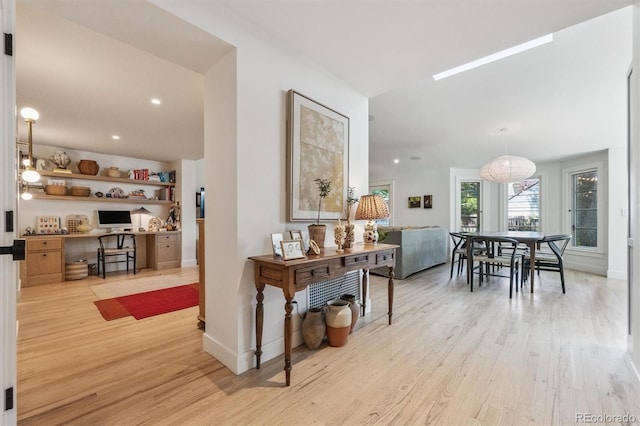 435 Ivanhoe St, Denver, CO 80220 - hall with light wood finished floors, a desk, and recessed lighting