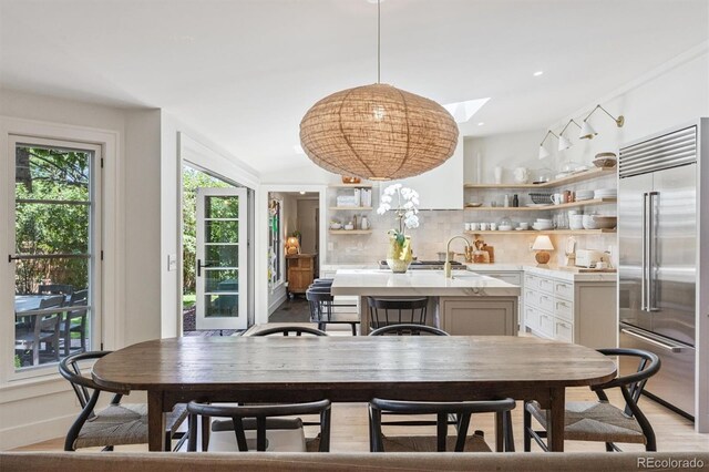 435 Ivanhoe St, Denver, CO 80220 - dining room with light wood-style floors and a skylight