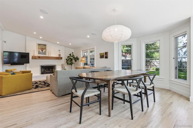 435 Ivanhoe St, Denver, CO 80220 - dining space featuring light wood-type flooring, a brick fireplace, lofted ceiling, and recessed lighting