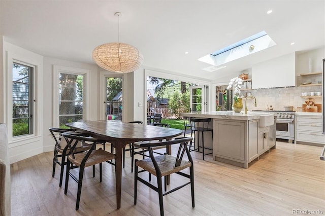 435 Ivanhoe St, Denver, CO 80220 - dining area with a skylight, light wood finished floors, plenty of natural light, and recessed lighting