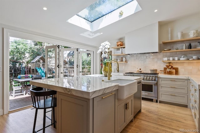 435 Ivanhoe St, Denver, CO 80220 - kitchen featuring high end range, open shelves, a skylight, decorative backsplash, and recessed lighting