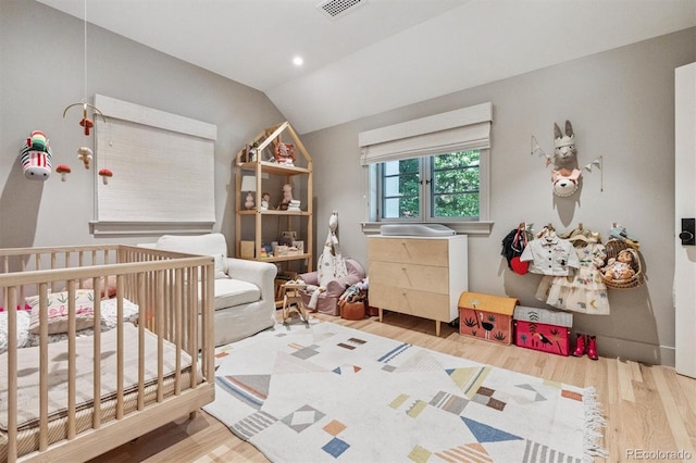 435 Ivanhoe St, Denver, CO 80220 - bedroom with vaulted ceiling, wood finished floors, a nursery area, and recessed lighting