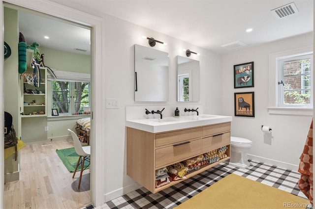 435 Ivanhoe St, Denver, CO 80220 - bathroom with double vanity, recessed lighting, and wood finished floors