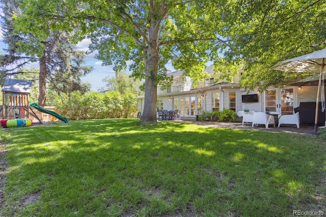 435 Ivanhoe St, Denver, CO 80220 - view of grassy yard featuring a playground