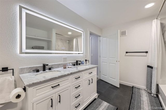 full bathroom featuring double vanity, a shower with curtain, visible vents, and a sink