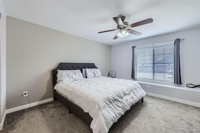 carpeted bedroom with visible vents, ceiling fan, and baseboards