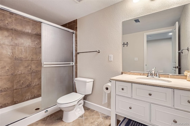 bathroom with vanity, a shower stall, toilet, and tile patterned floors