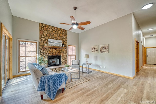 318 Southgate Rd, Florissant, CO 80816 - living room featuring light wood-style floors, ceiling fan, lofted ceiling, baseboards, and a fireplace