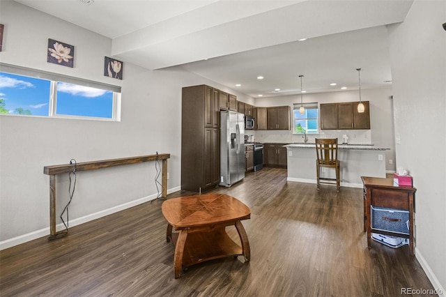 7956 Osage St, Denver, CO 80221 - living room featuring dark wood-style flooring and recessed lighting