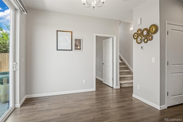 7956 Osage St, Denver, CO 80221 - empty room with stairs, wood finished floors, and a chandelier
