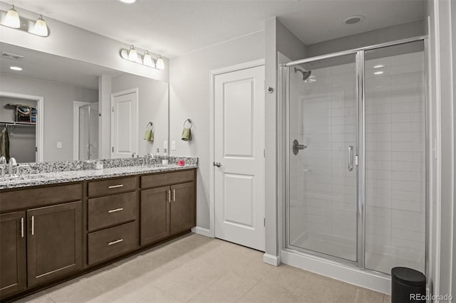 7956 Osage St, Denver, CO 80221 - bathroom with double vanity, a stall shower, and tile patterned flooring