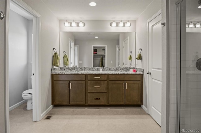 7956 Osage St, Denver, CO 80221 - full bathroom featuring double vanity, a tile shower, tile patterned flooring, and recessed lighting