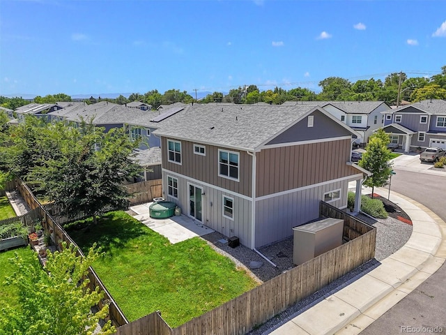 7956 Osage St, Denver, CO 80221 - rear view of property with a residential view, a fenced backyard, a shingled roof, and a patio