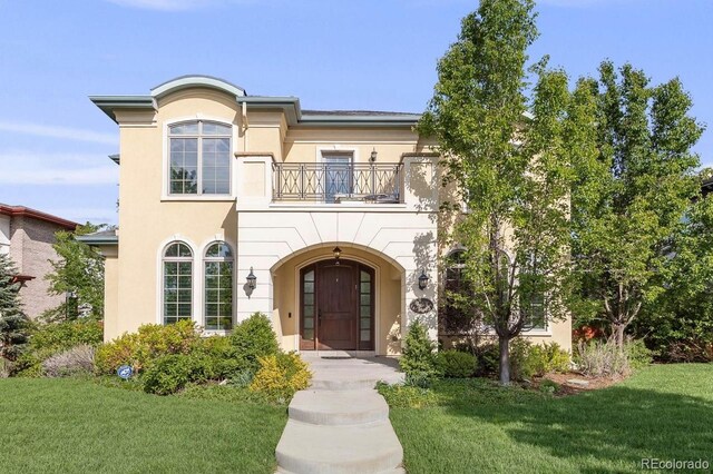 2362 Spruce Way, Denver, CO 80238 - view of front of house featuring a balcony, stucco siding, and a front lawn