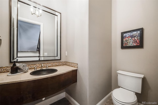 2362 Spruce Way, Denver, CO 80238 - half bath featuring toilet, vanity, and baseboards