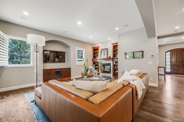 2362 Spruce Way, Denver, CO 80238 - living room with a premium fireplace, wood finished floors, baseboards, recessed lighting, and arched walkways