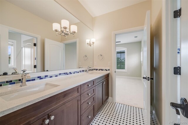 2362 Spruce Way, Denver, CO 80238 - full bath with a chandelier, double vanity, and baseboards