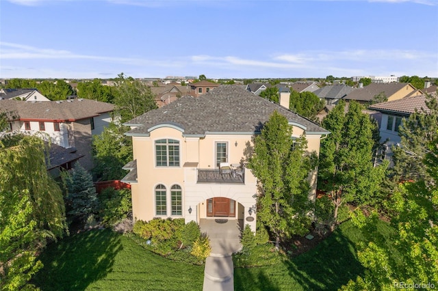 2362 Spruce Way, Denver, CO 80238 - french country style house featuring stucco siding, a balcony, a front yard, a chimney, and a residential view