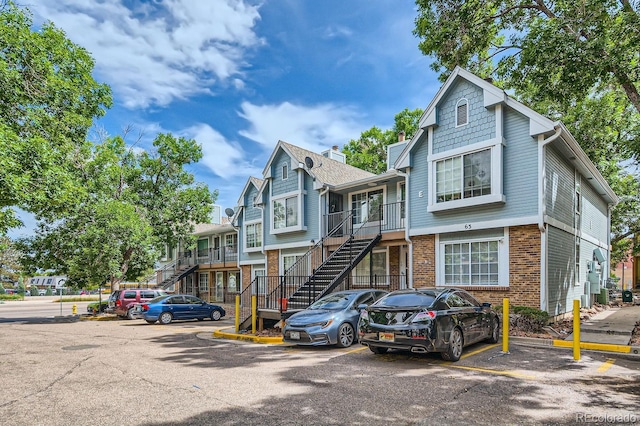 63 S Sable Blvd Unit E22, Aurora, CO 80012 - townhome / multi-family property with stairway, uncovered parking, brick siding, and a residential view