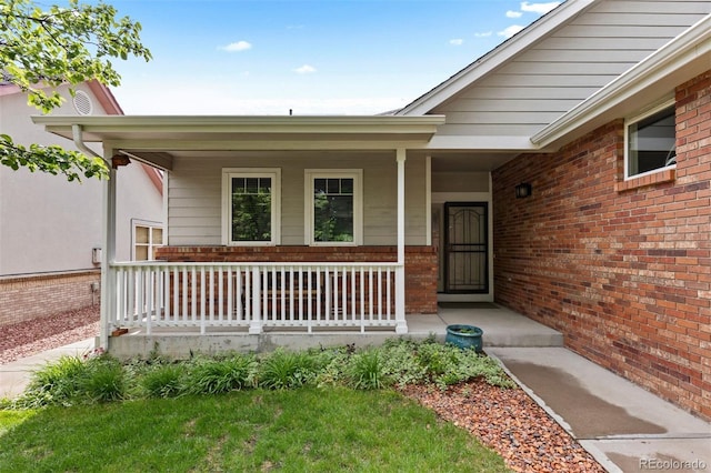1901 S Union Pl, Lakewood, CO 80228 - property entrance featuring covered porch and brick siding