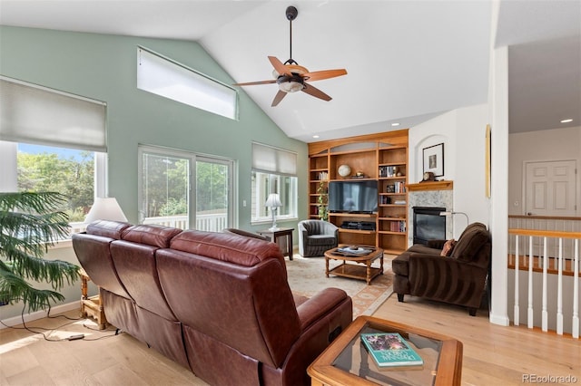 1901 S Union Pl, Lakewood, CO 80228 - living area with light wood-type flooring, a ceiling fan, a fireplace, and high vaulted ceiling